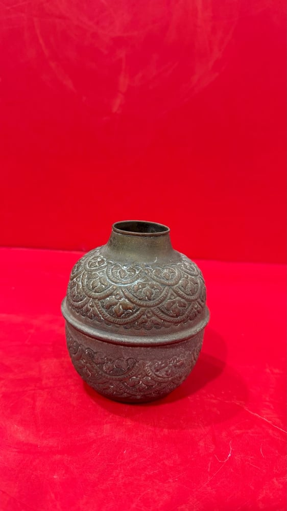 A carved copper vase