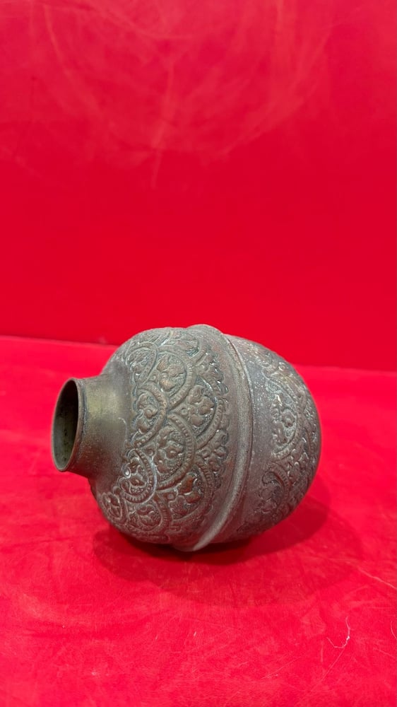 A carved copper vase
