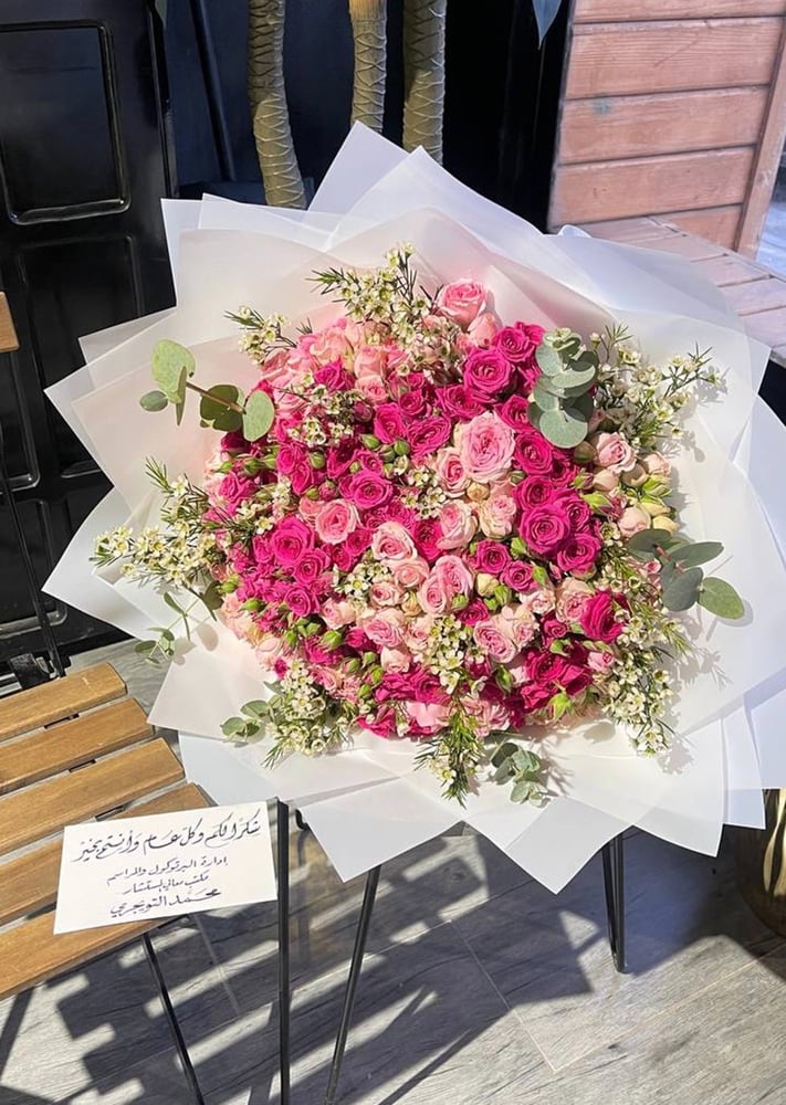 A bouquet of mixed flowers with transparent white wrapping