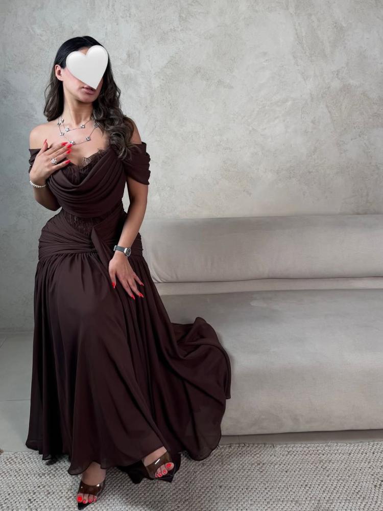 A luxurious brown dress with off-shoulder and flowing feminine pleats