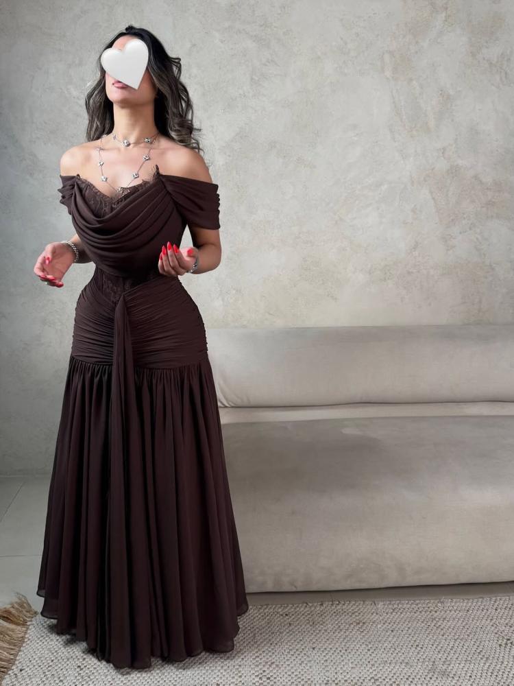 A luxurious brown dress with off-shoulder and flowing feminine pleats