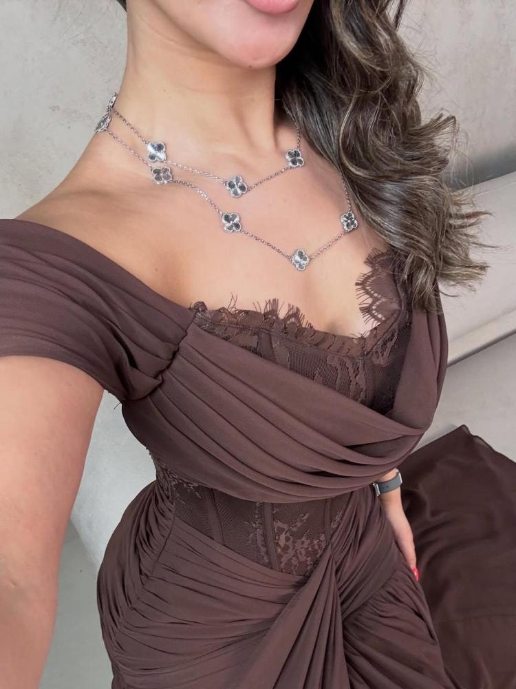 A luxurious brown dress with off-shoulder and flowing feminine pleats
