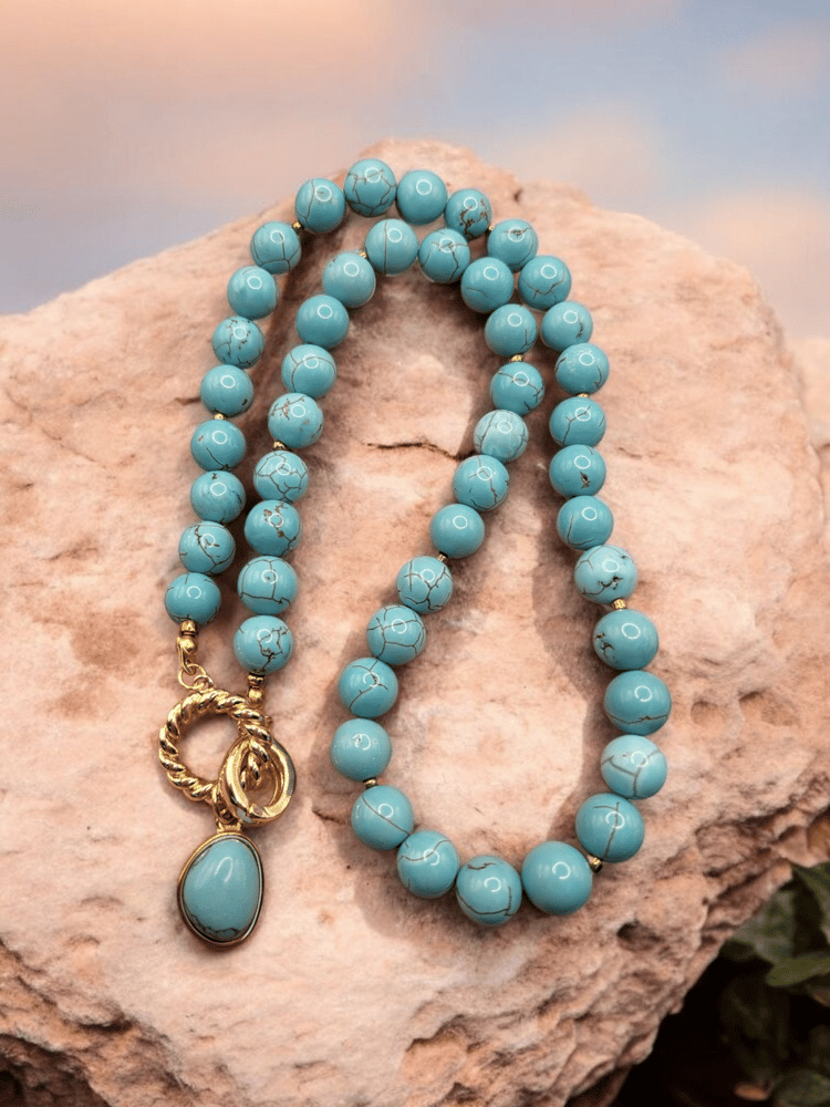 Elegant necklace of Brazilian turquoise decorated with gold-plated charm.
