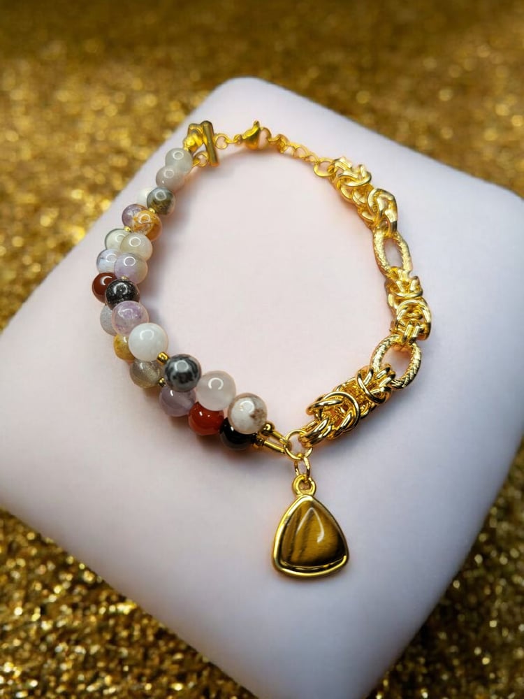 Elegant plated bracelet from a collection of natural stones that enhance mental calmness, amethyst, peacock stone, moonstone, with agate decorated with charms of natural tiger's eye stone