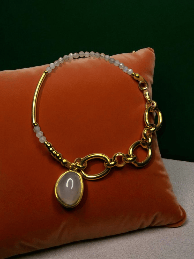 A bracelet with a distinctive design made of valuable peacock stone, the size of the stone is 2mm, and decorated with gold-plated charms made of peacock stone.