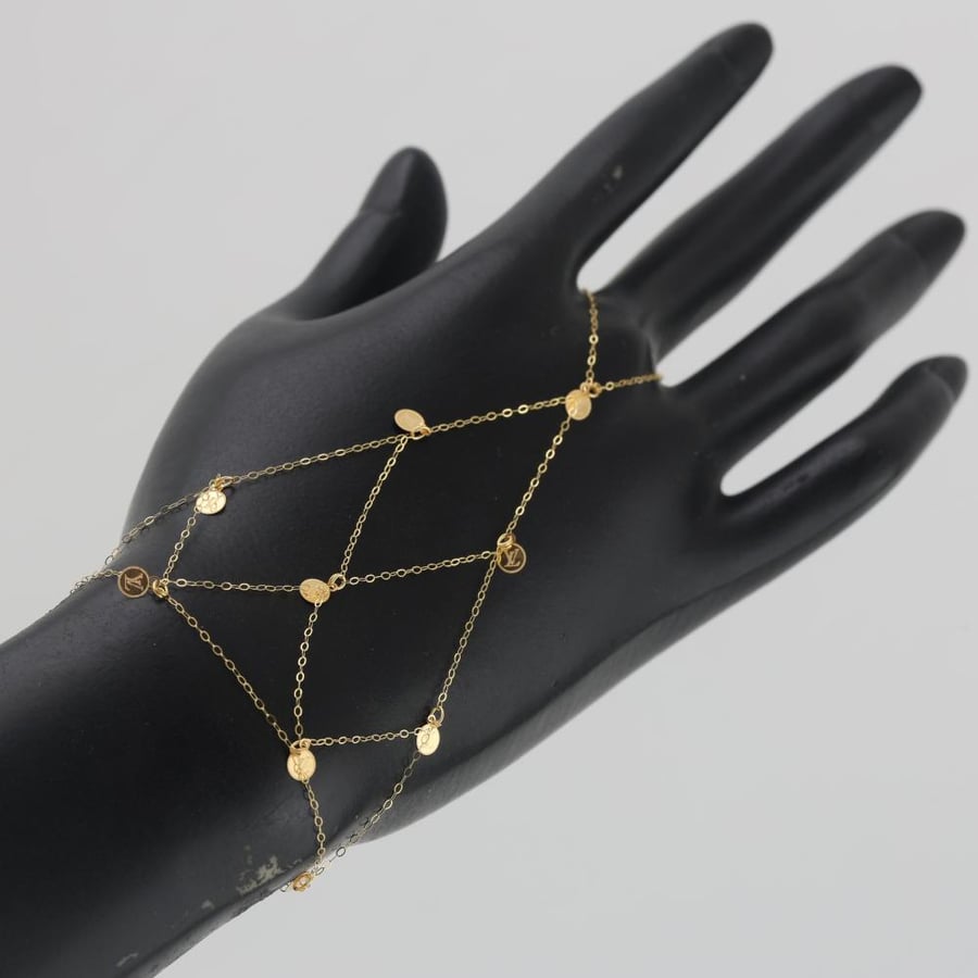 A striking gold cuff with circular embellishments - 21 carat
