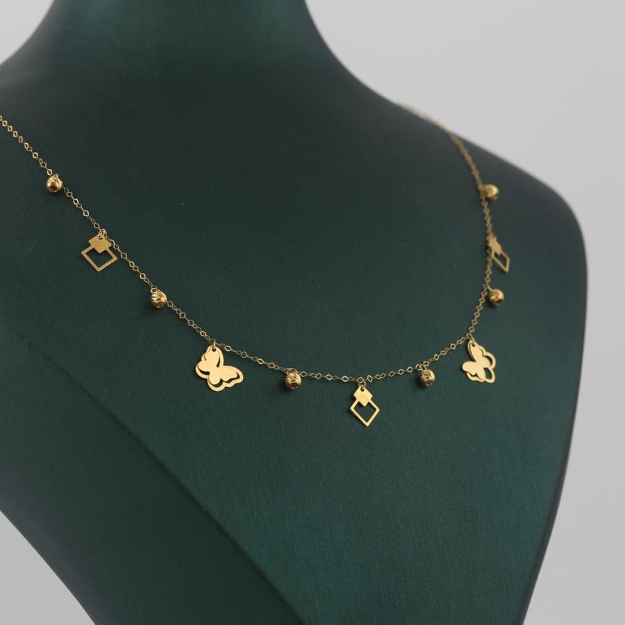 Gold charm with butterflies and a shiny eye - 18 karat