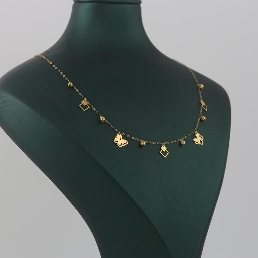 Gold charm with butterflies and a shiny eye - 18 karat