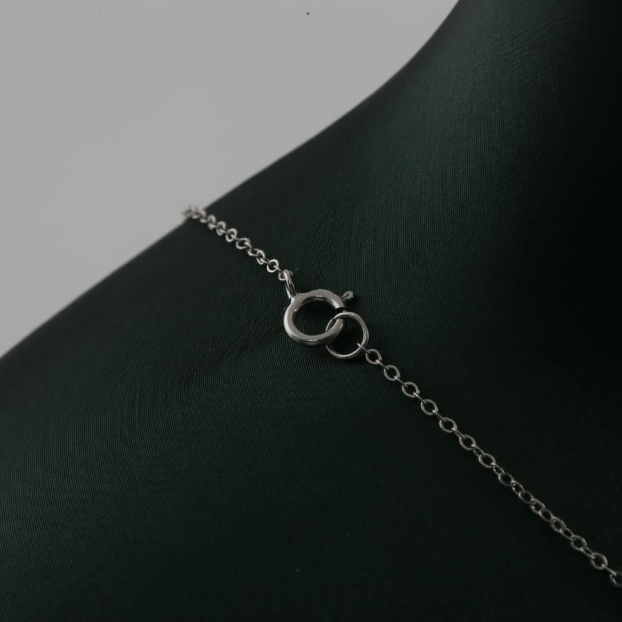 White gold ring with V letter design and a specific pendant - 18 karat