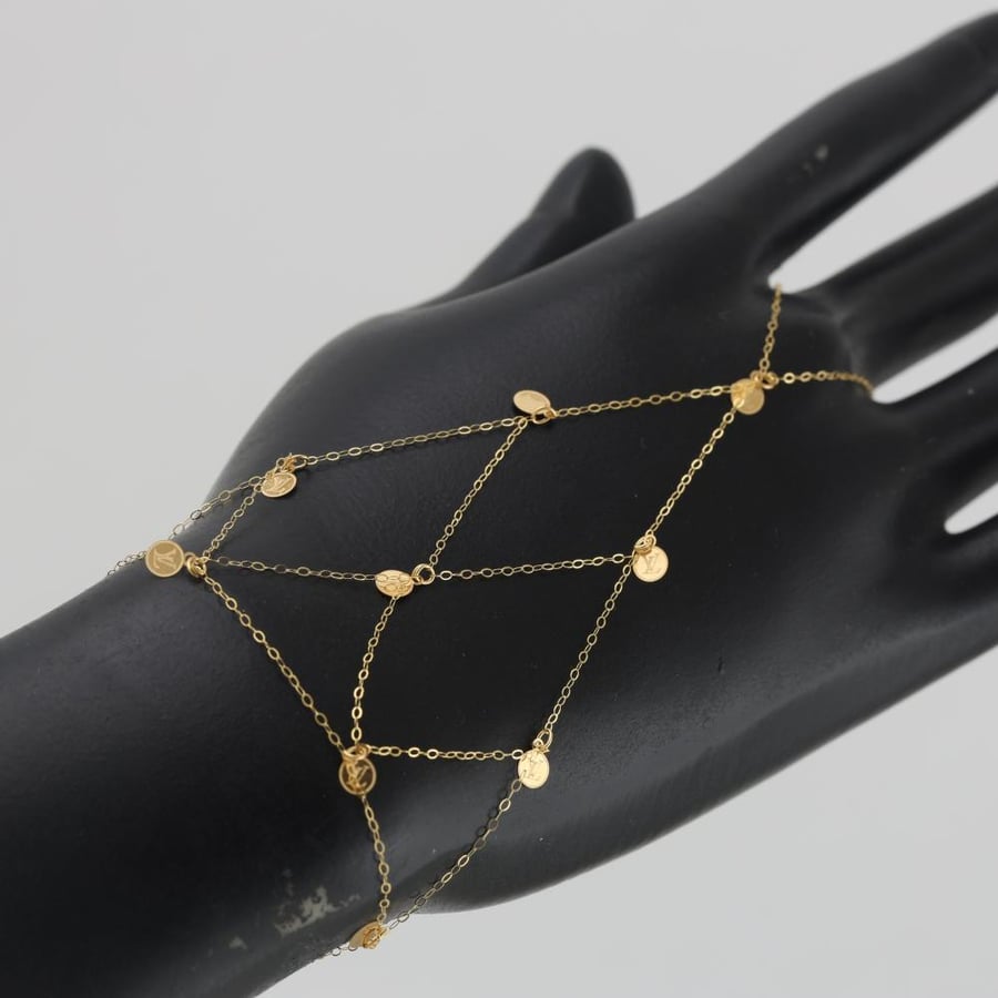 A striking gold cuff with circular embellishments - 21 carat