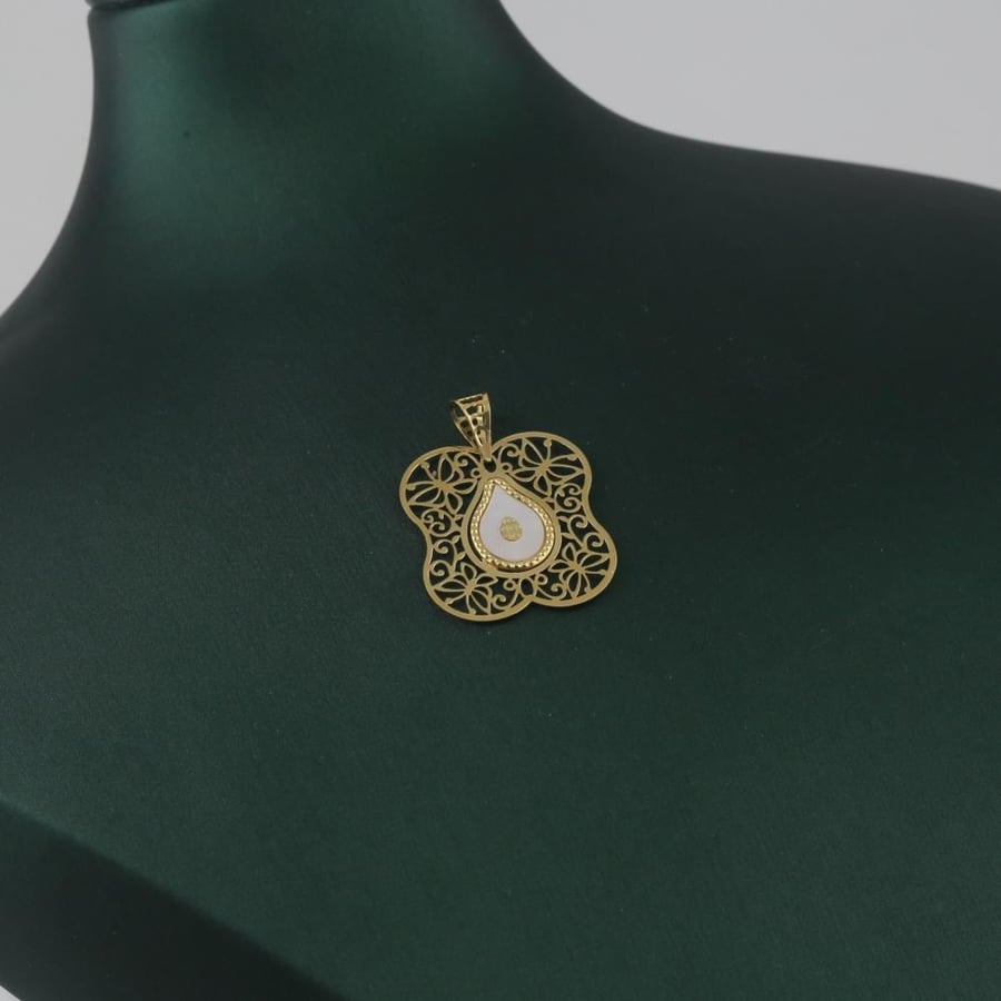A distinctive gold pendant with a striking white tear - 18 karat