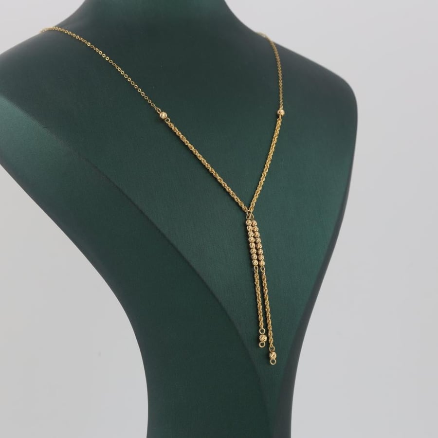 Gold bracelet with a double twisted design and laser balls - 21 karat