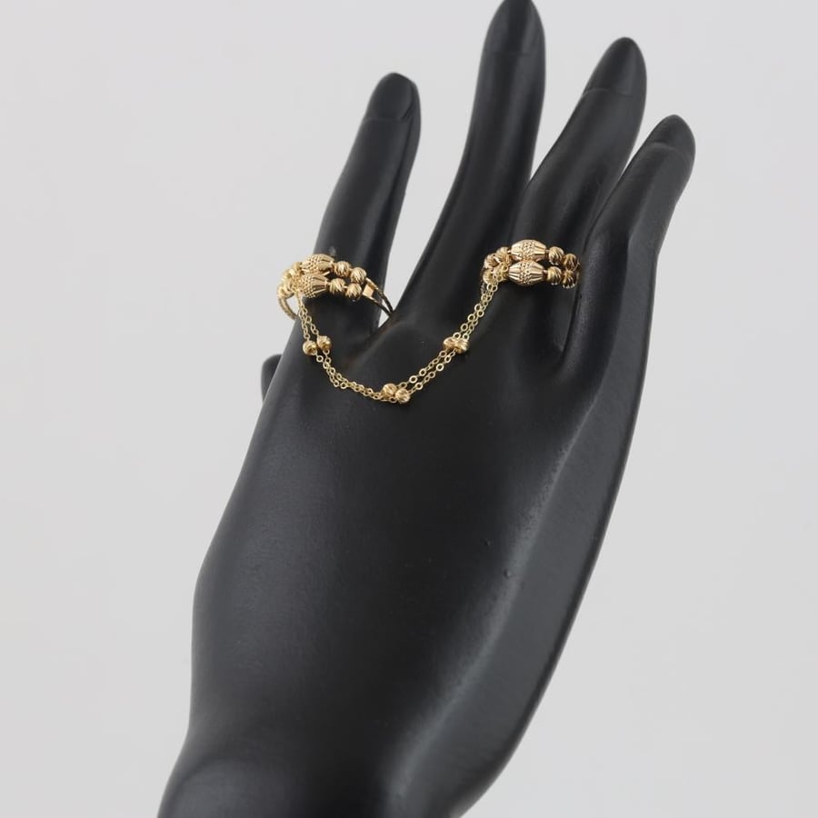 Gold ring with strings, balls, and laser shapes - 21 karat