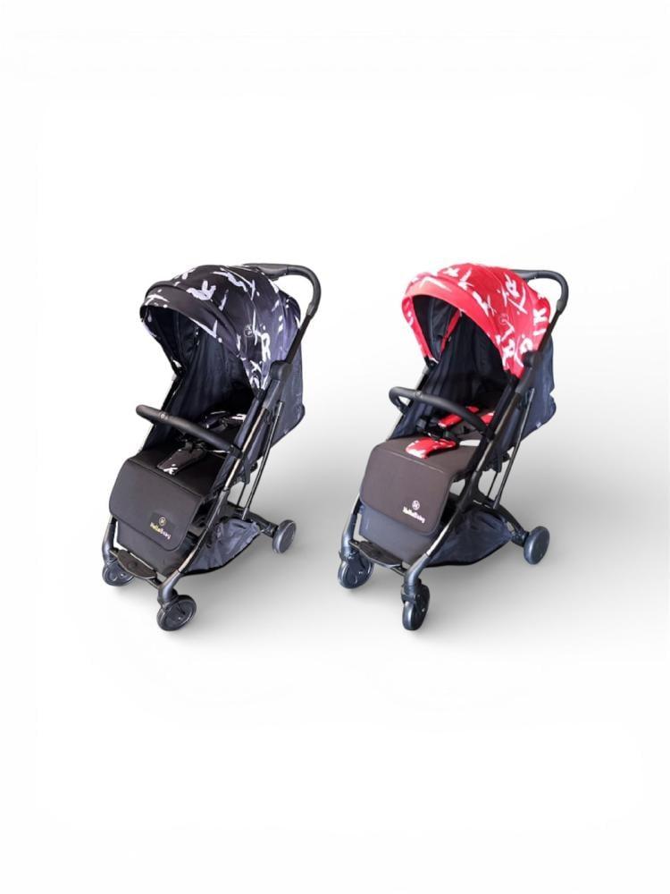 Stroller in black color with red drawings on the canopy, foldable