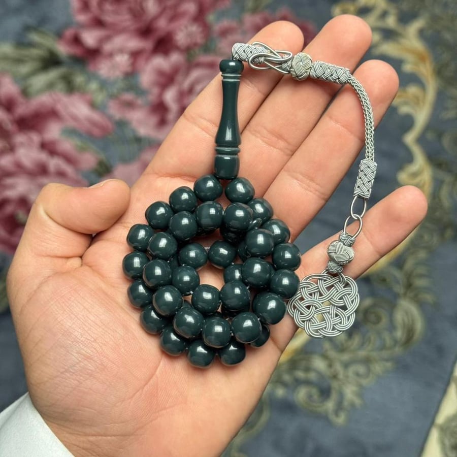 Transparent amber-colored prayer beads with brass accents