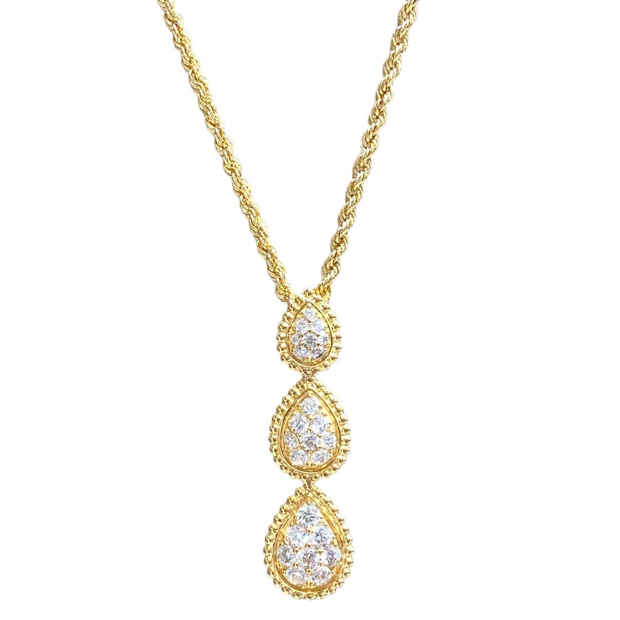A gold ring with three tears in diamond design