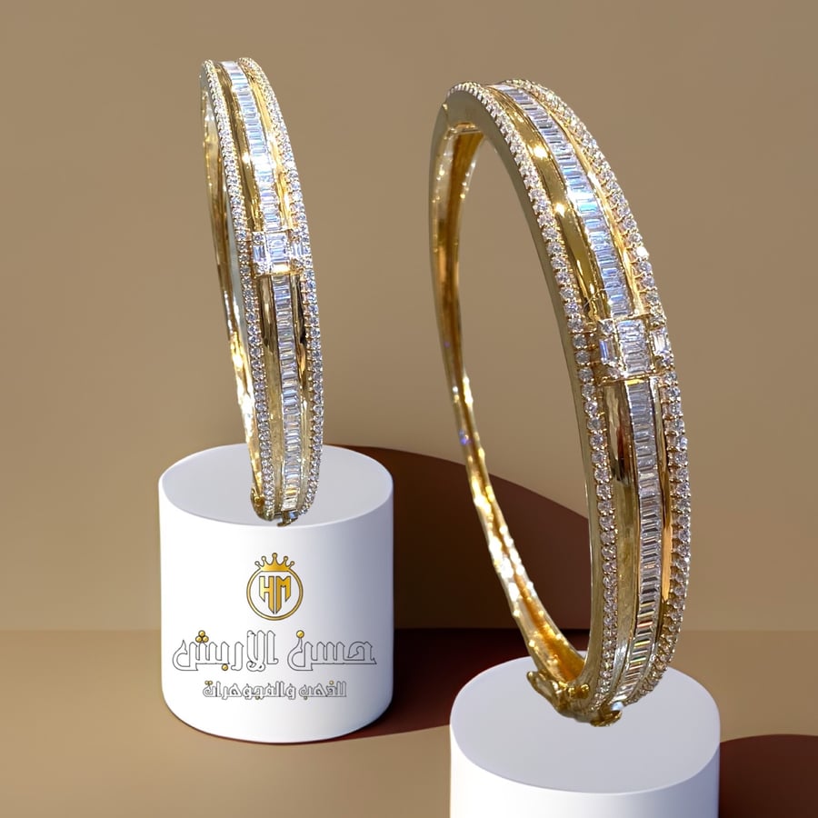 A gold bracelet with a diamond design