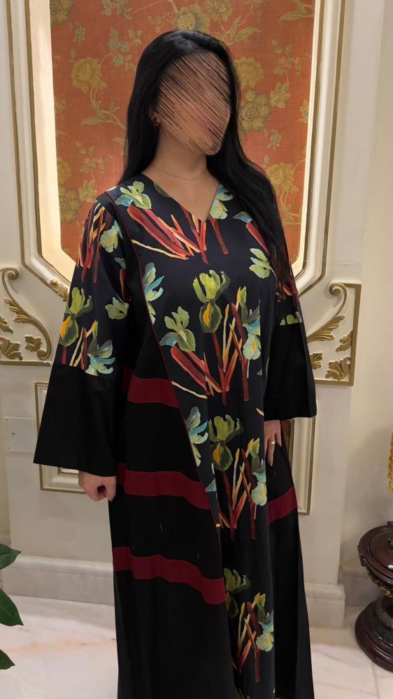 Black thobe with colorful floral patterns and wide sleeve design.