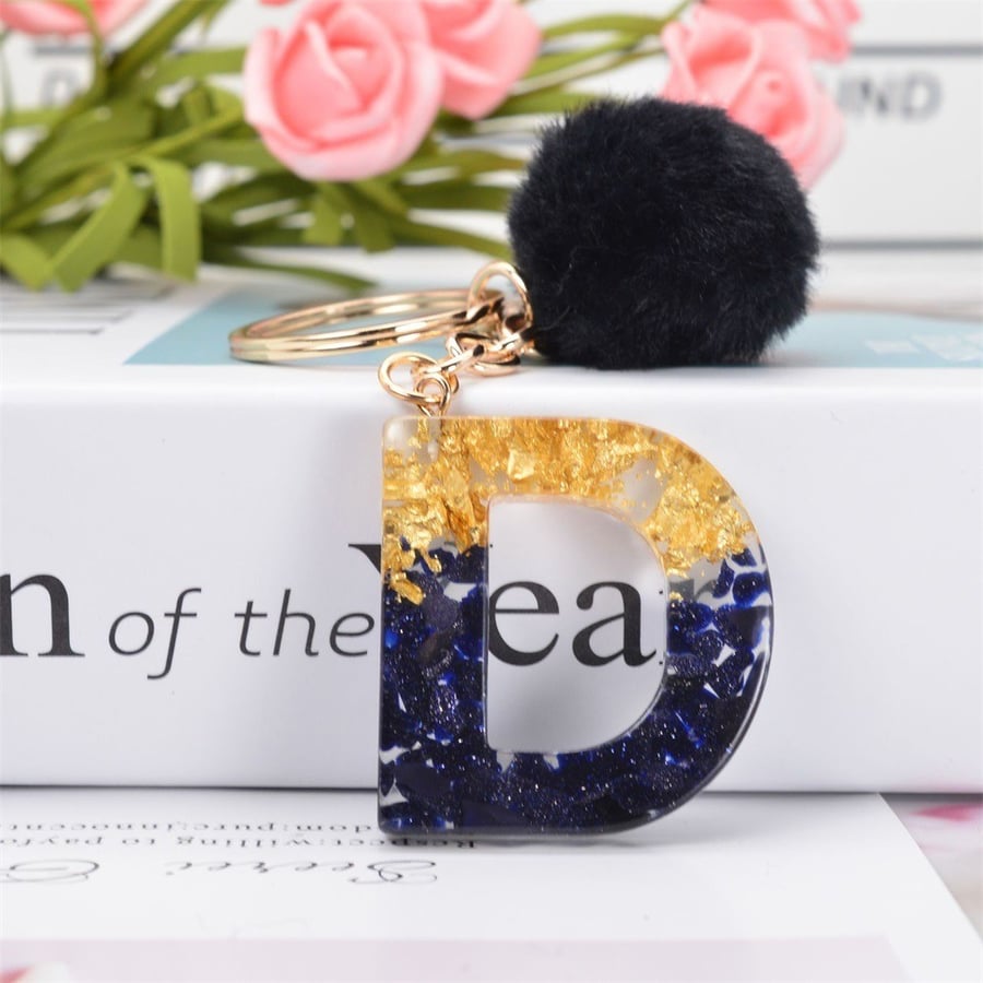 Medal and keychain in the shape of English letters and a black fuzzy ball / assorted letters