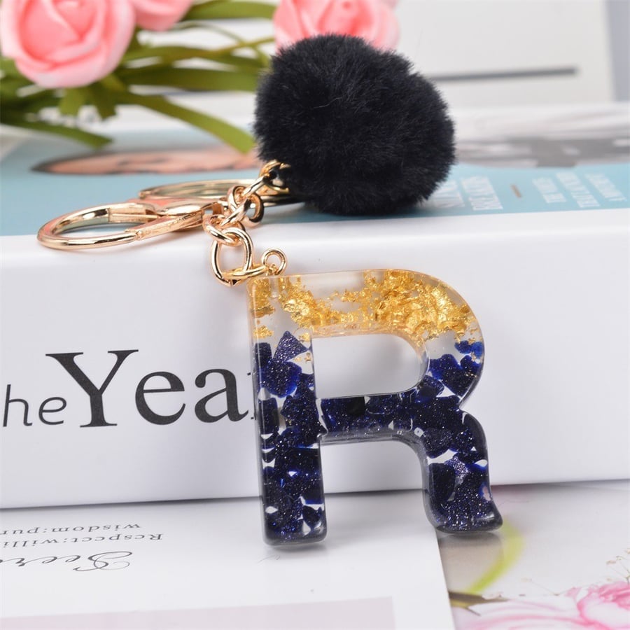 Medal and keychain in the shape of English letters and a black fuzzy ball / assorted letters