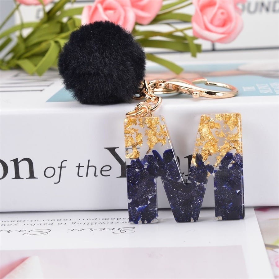 Medal and keychain in the shape of English letters and a black fuzzy ball / assorted letters