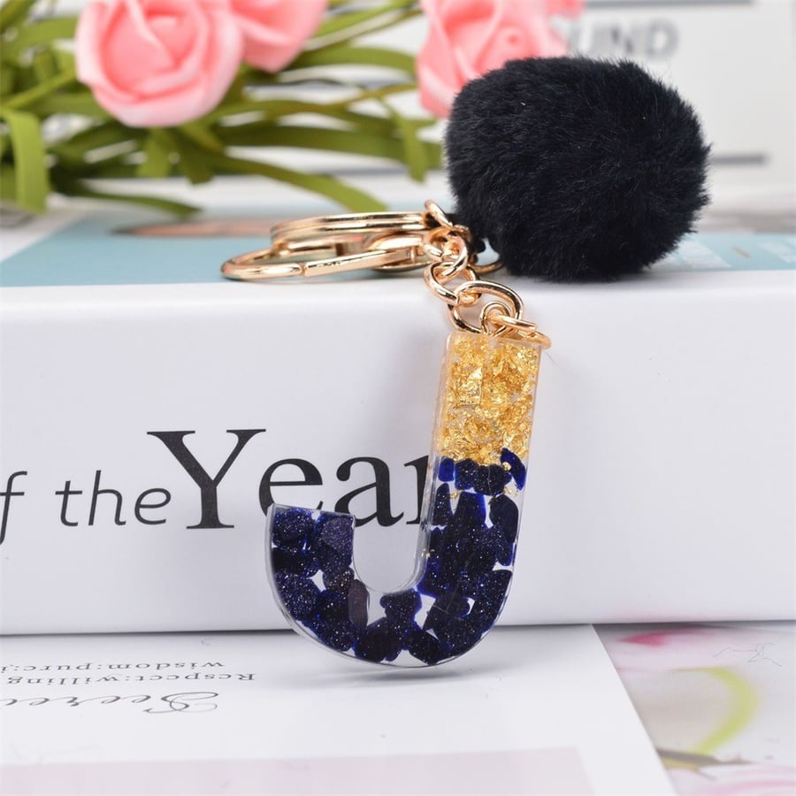 Medal and keychain in the shape of English letters and a black fuzzy ball / assorted letters