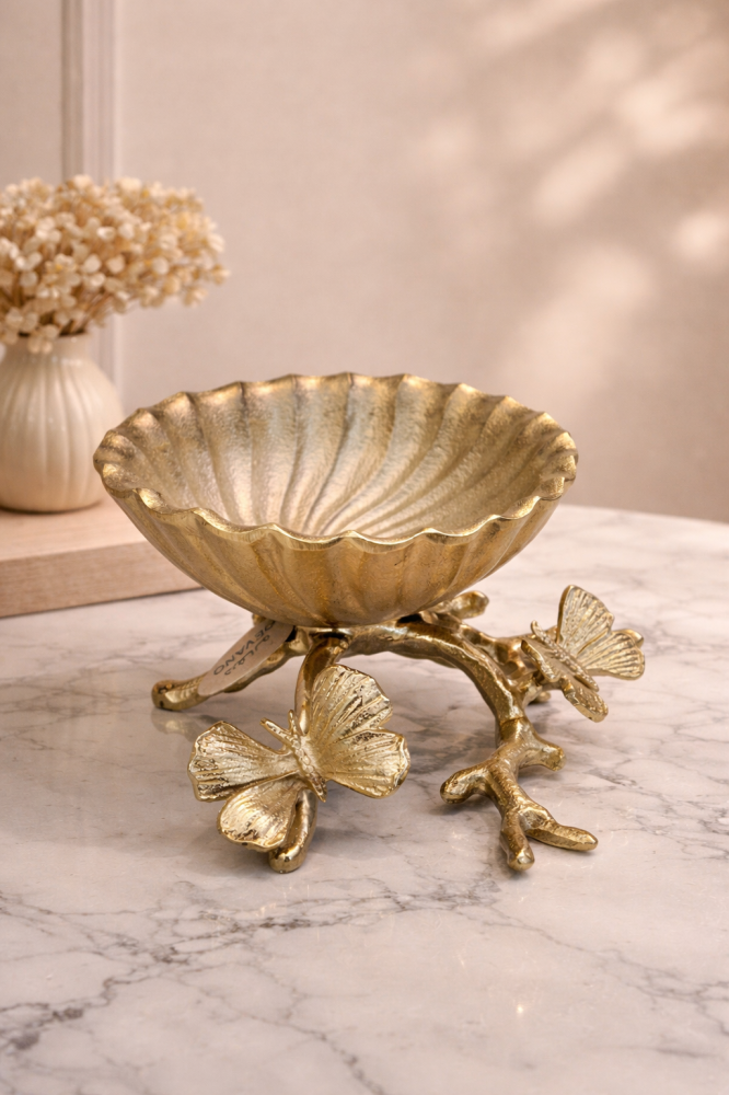 Luxury serving bowl with a shell design and a base decorated with butterflies