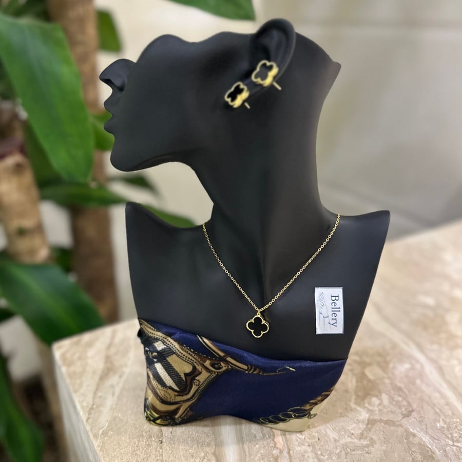 A flower pendant with a black-colored earring