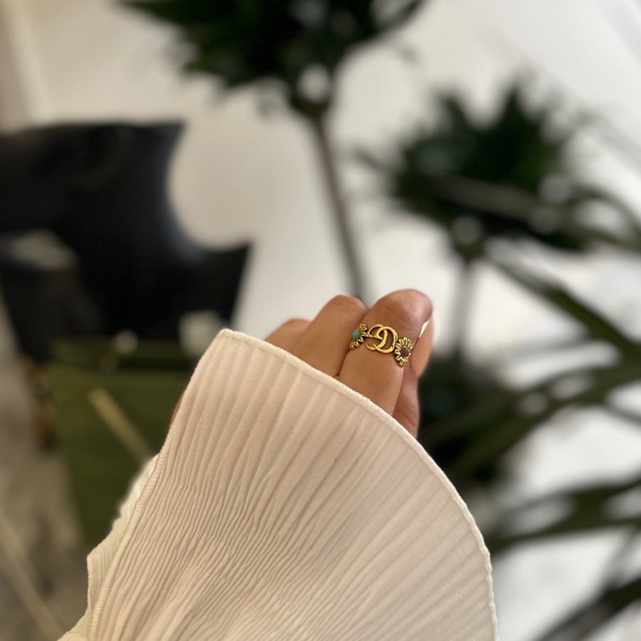 Gold ring with colored flowers