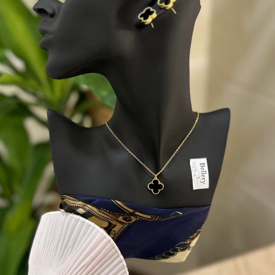 A flower pendant with a black-colored earring