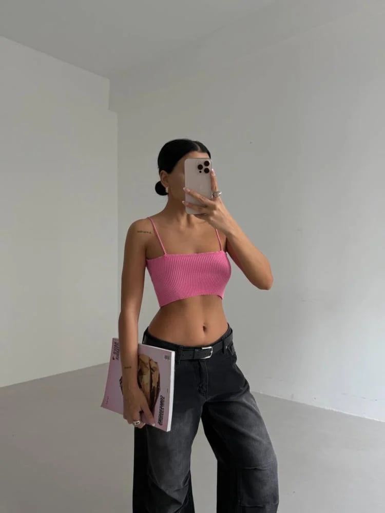 Pink crop top with thin straps and stretchy ribbed fabric