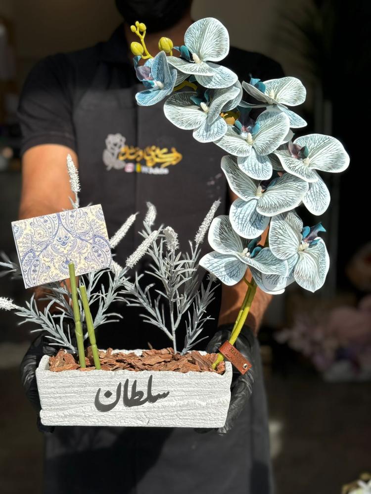 Rectangular cement vase with orchid and lavender