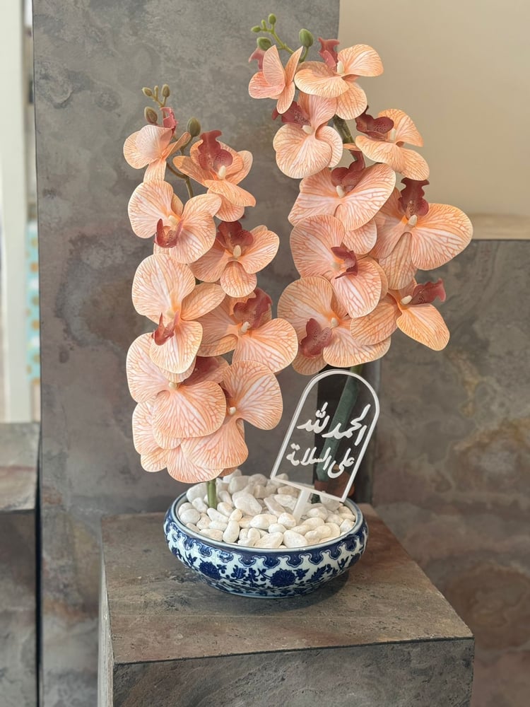Ceramic vase with orchid flowers