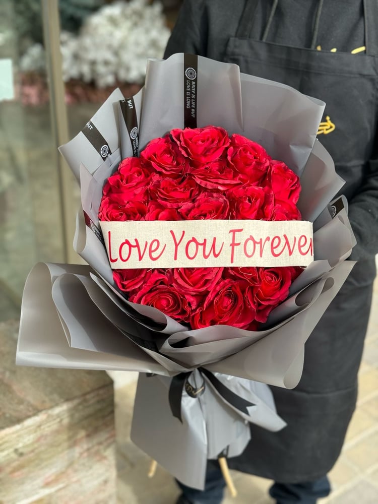 Valentine's Day bouquet with artificial red roses and a phrase