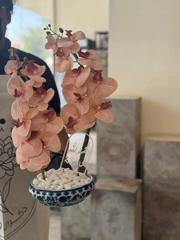 Ceramic vase with orchid flowers