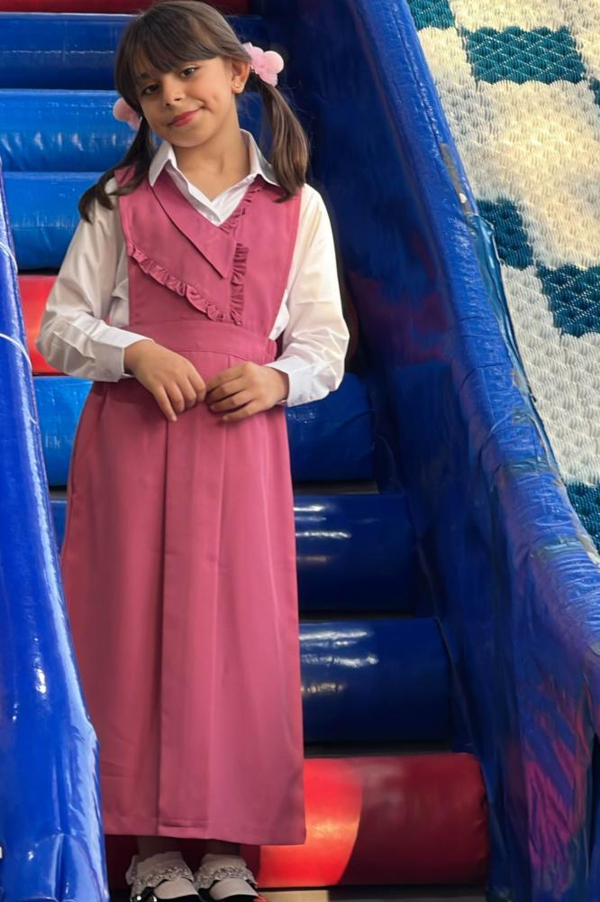 Girls' pink apron set for elementary with a white shirt