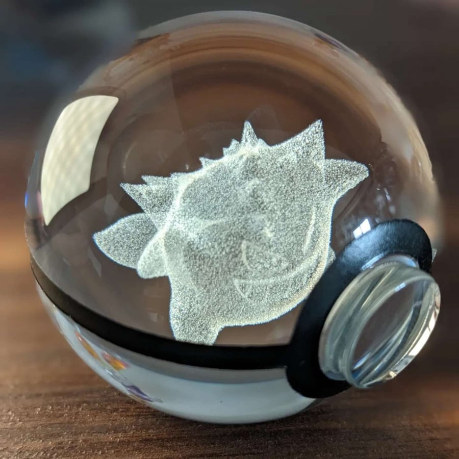 Glass Pokémon ball with illuminated base.