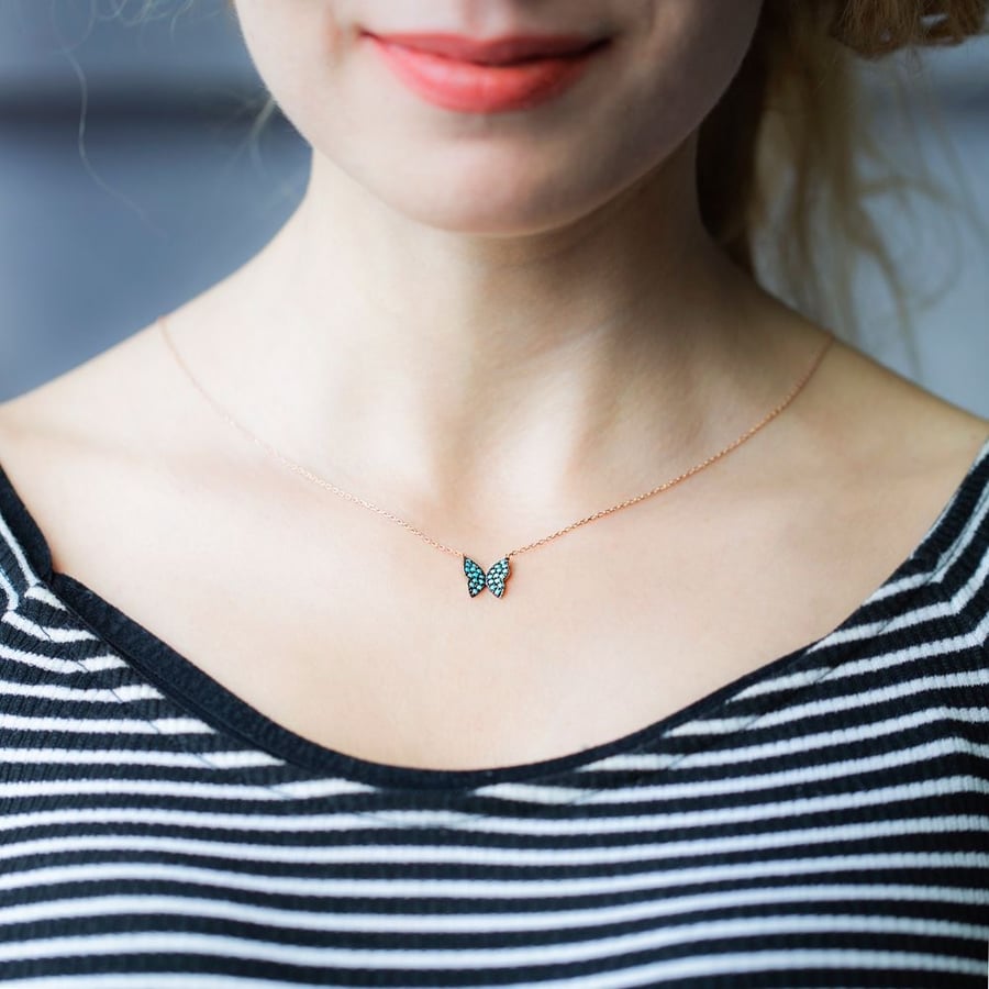 The glowing butterfly pendant encrusted with turquoise zircon stones and plated with pure gold - from Nafis Jewelry Gift Collection, luxury women's gift 1456