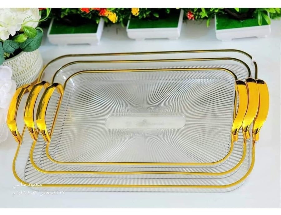 A transparent acrylic Basteen set with a gold handle, consisting of 3 pieces