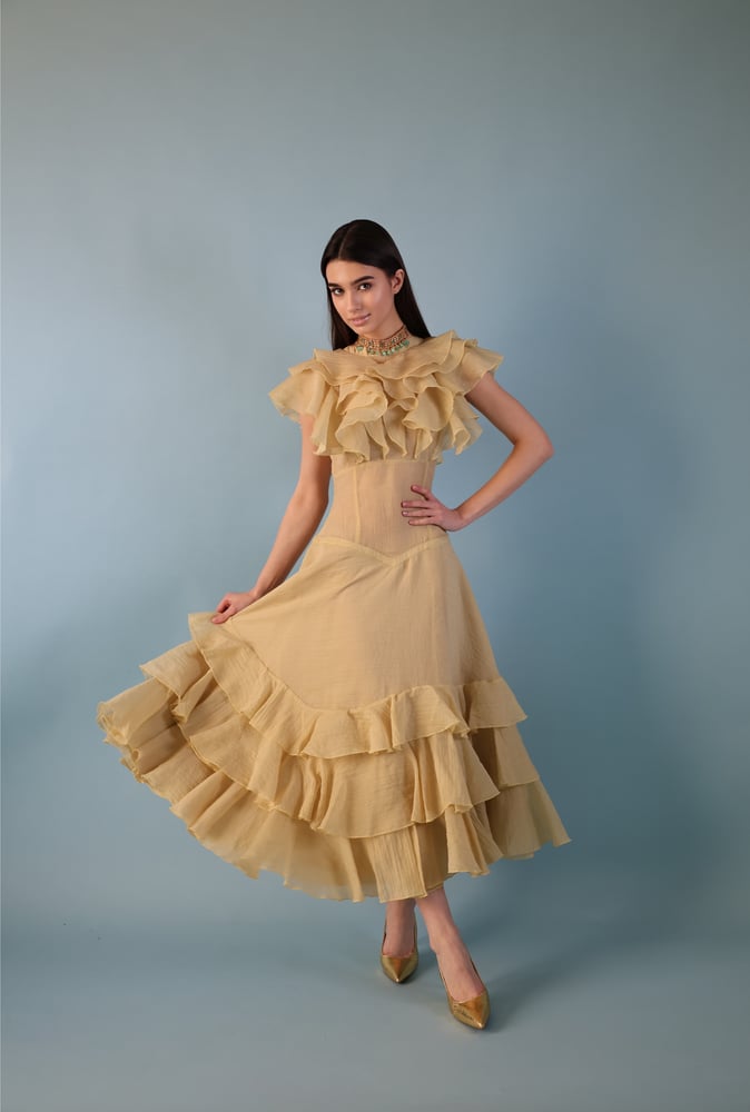 A beige-yellowish dress with a distinctive design made of georgette fabric