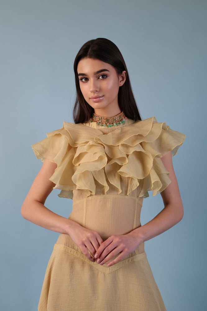 A beige-yellowish dress with a distinctive design made of georgette fabric