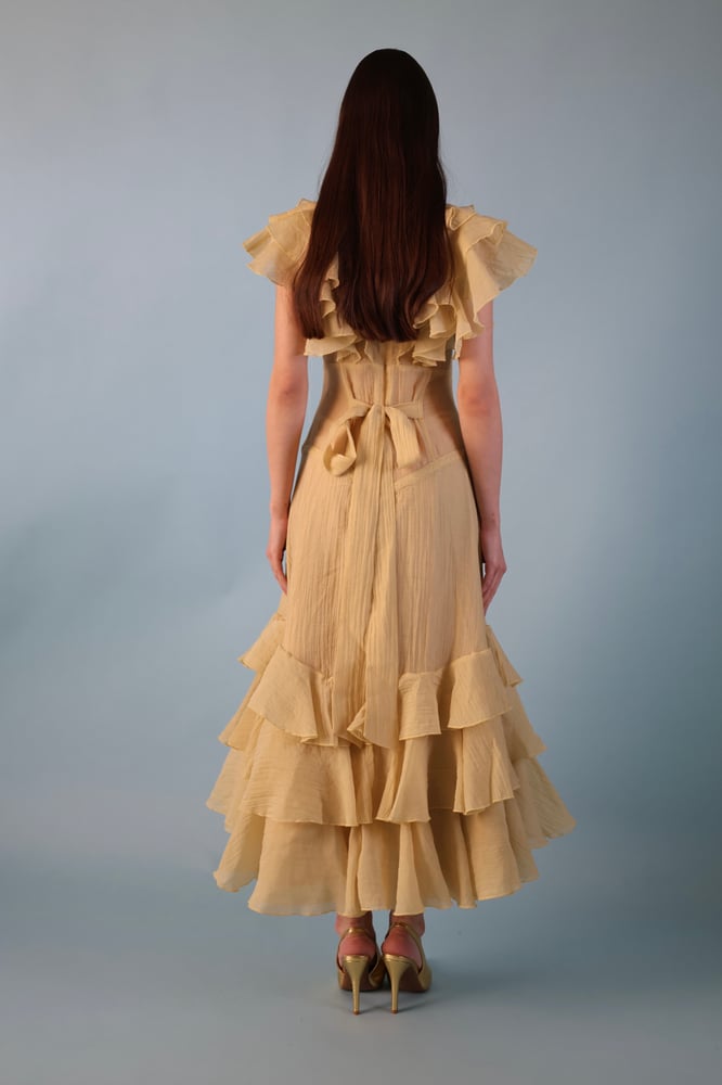 A beige-yellowish dress with a distinctive design made of georgette fabric