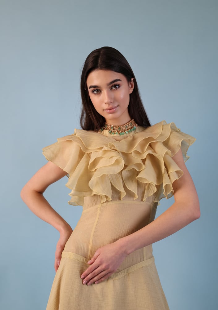 A beige-yellowish dress with a distinctive design made of georgette fabric