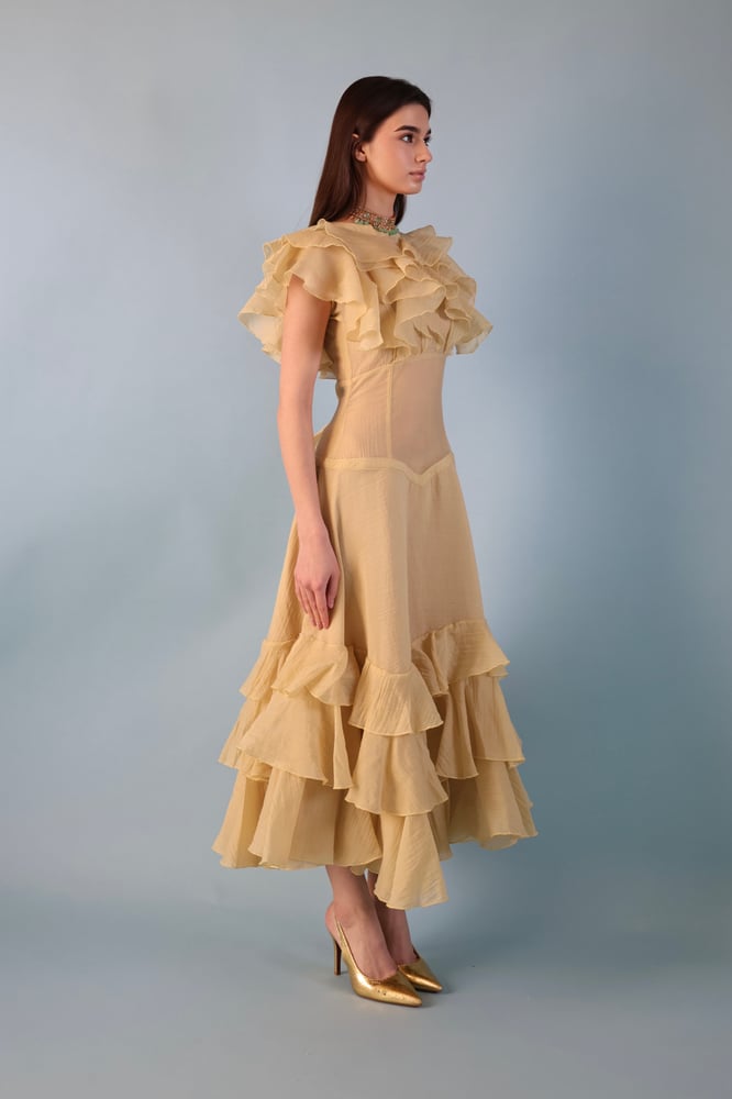 A beige-yellowish dress with a distinctive design made of georgette fabric