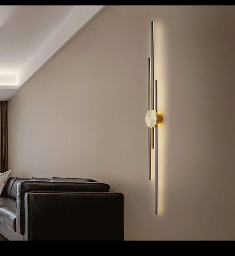 Luxury modern wall applique with a design of "intersecting linear columns" in gold.