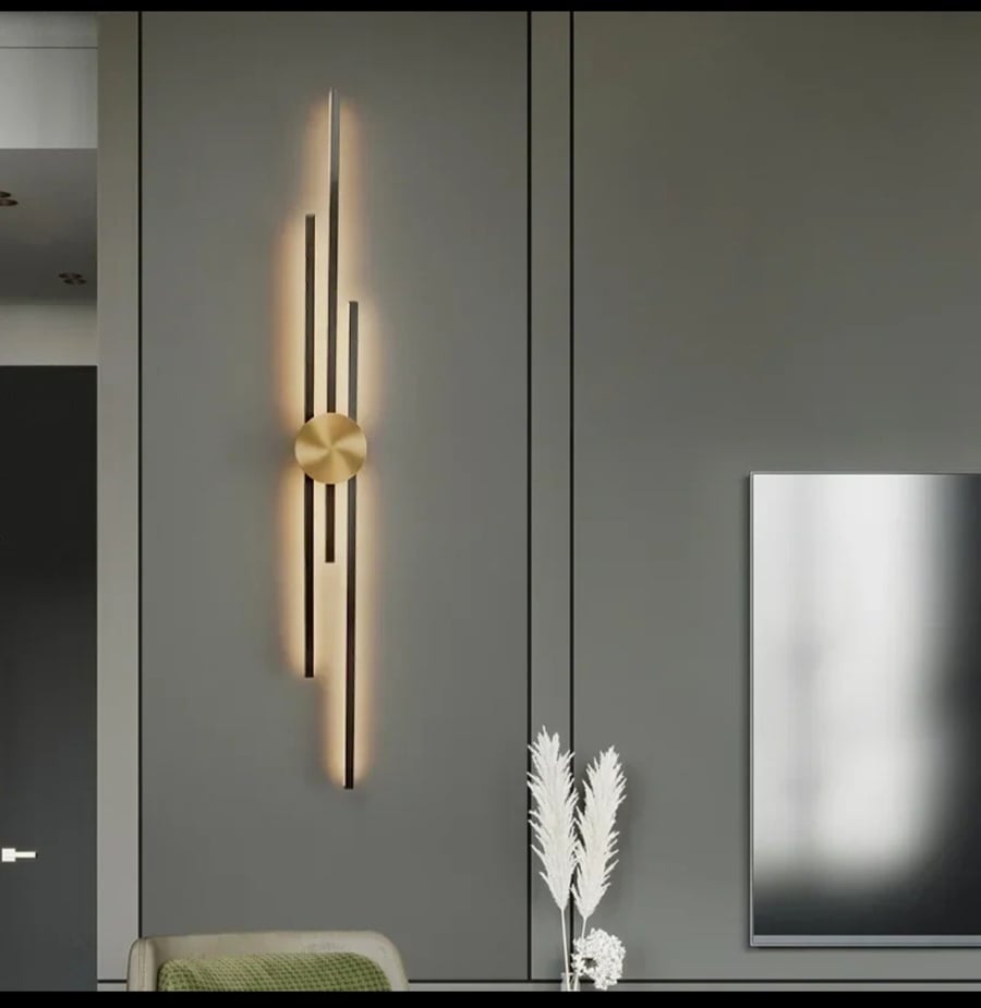 Luxury modern wall applique with a design of "intersecting linear columns" in gold.