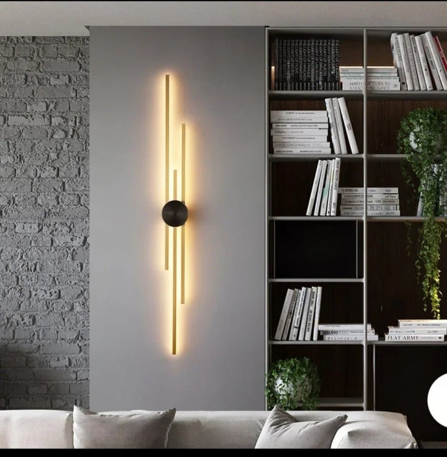 Luxury modern wall applique with a design of "intersecting linear columns" in gold.