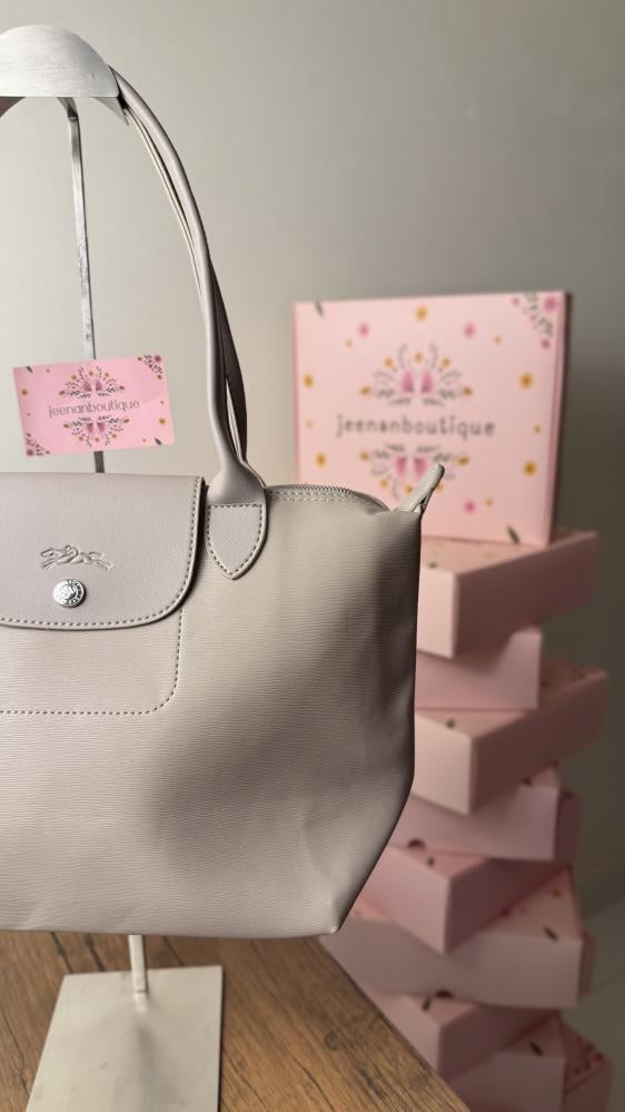 Long champagne-colored leather bag