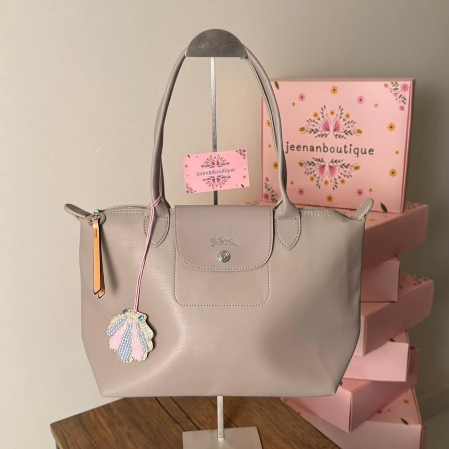 Long champagne-colored leather bag