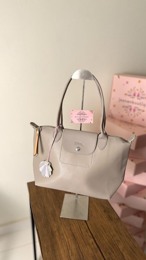 Long champagne-colored leather bag